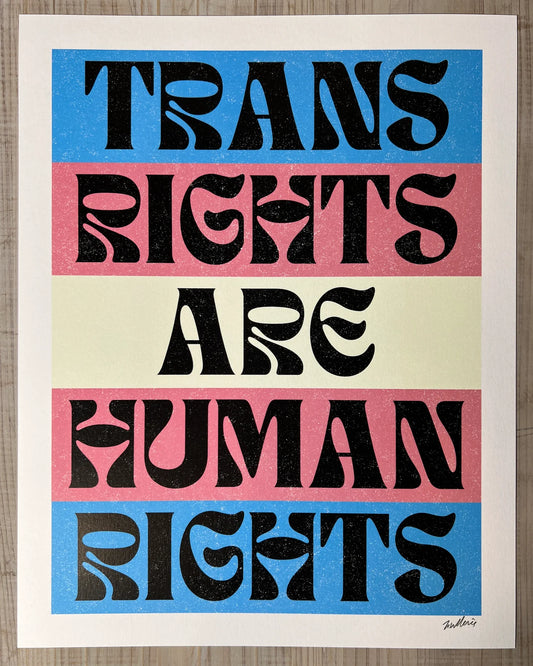 Poster with 'Trans Rights Are Human Rights' text in black on a blue, pink, and beige striped background.